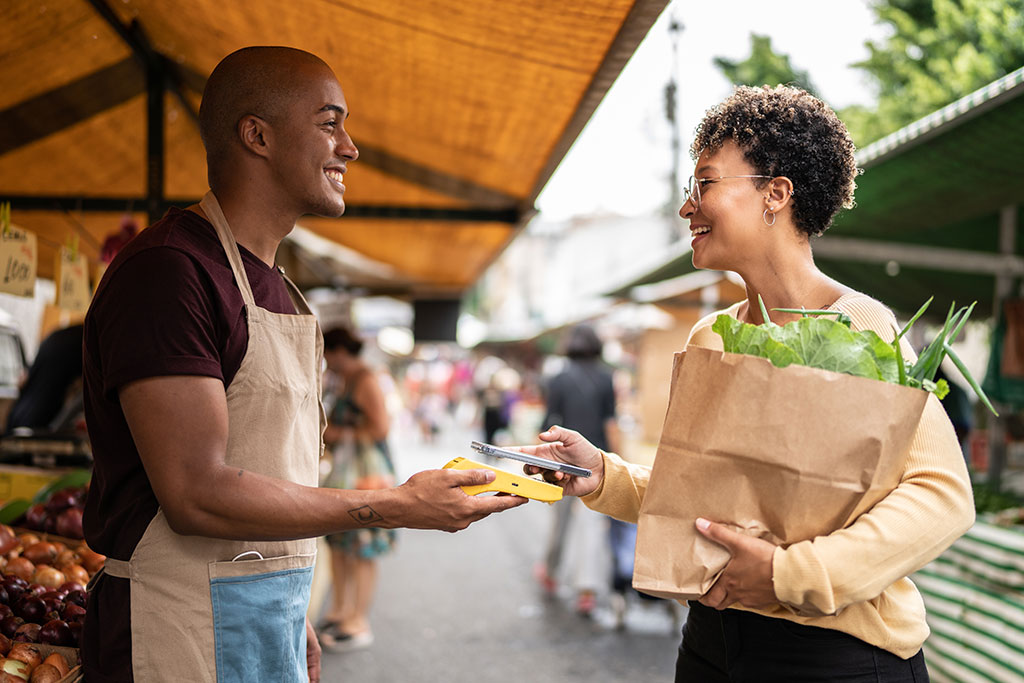 Woman at farmer's market buying groceries