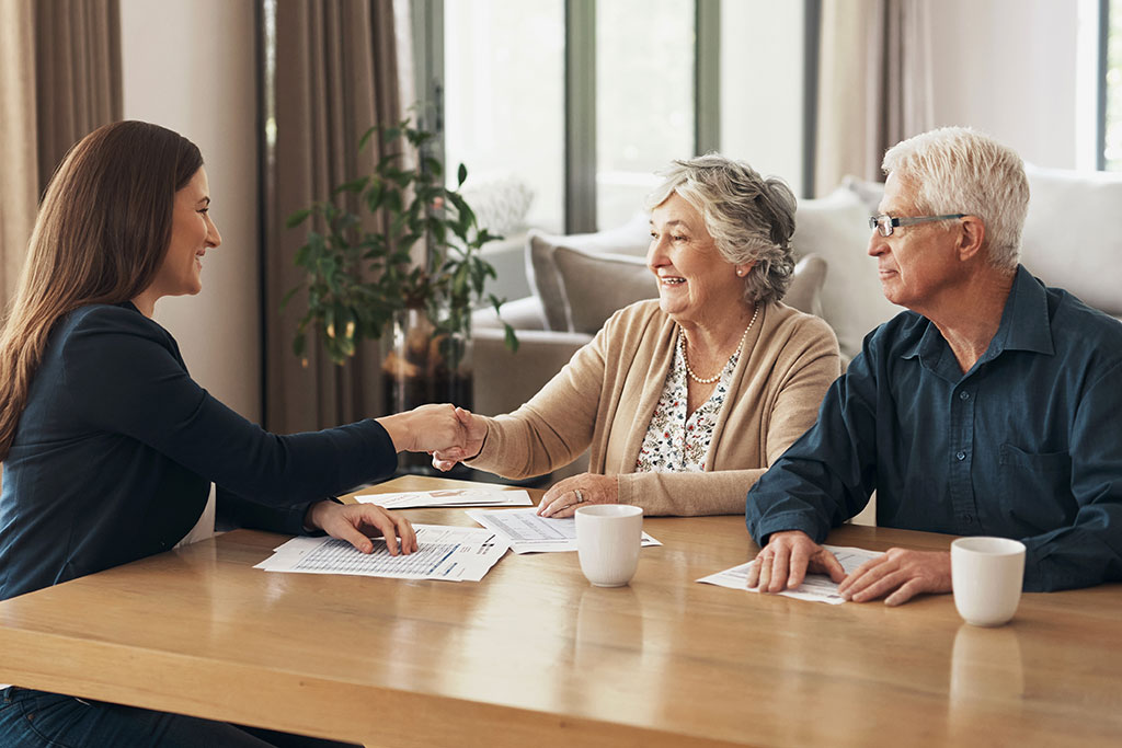 Older couple talking with financial advisor