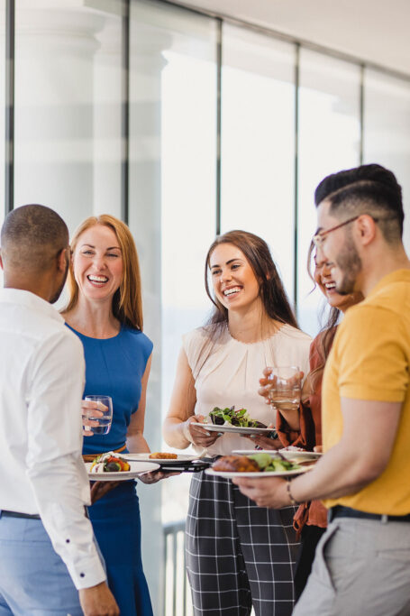 Group of co-workers talking at event