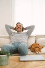 Man relaxing on couch with dog