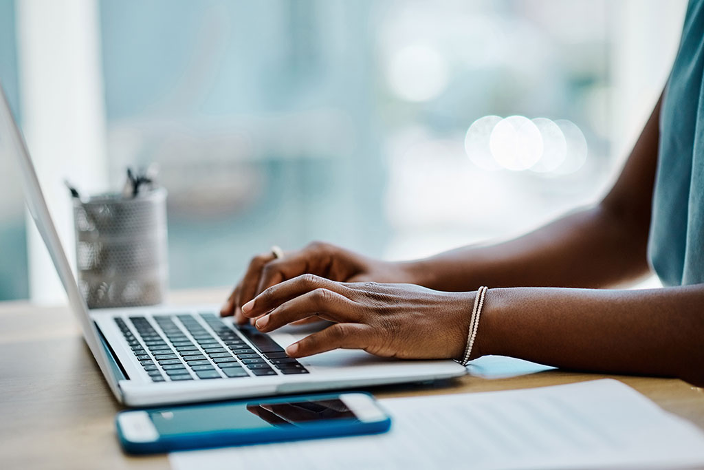 Woman typing on laptop