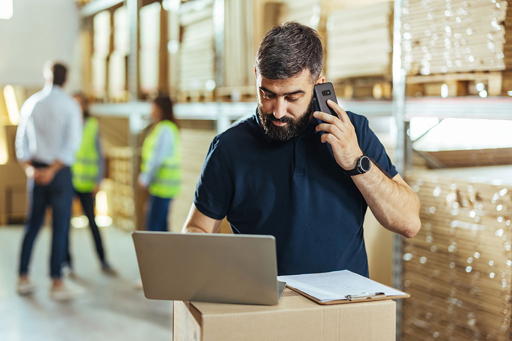 Business man on phone in warehouse