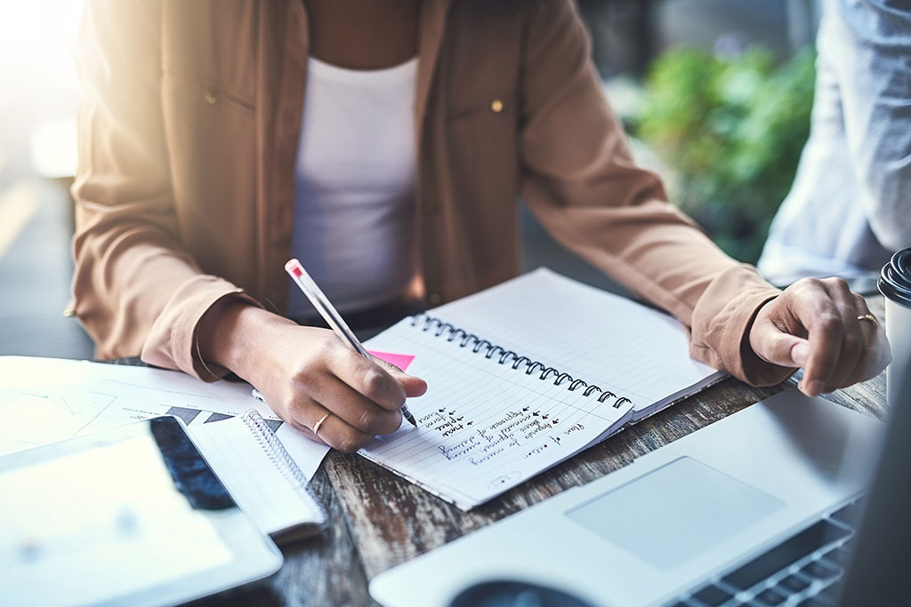 Woman writing in planner