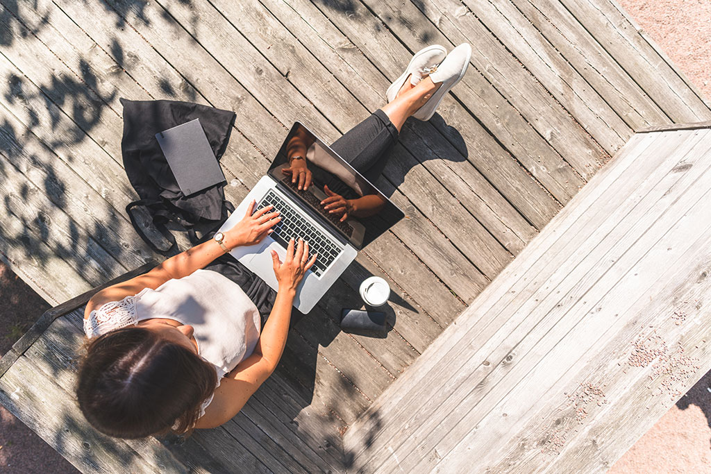 Woman outside using laptop