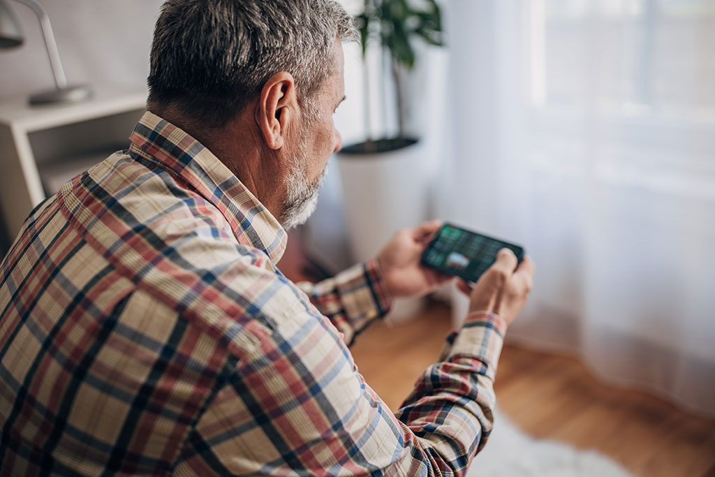 Older man playing phone game