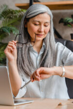 Business woman looking down at watch