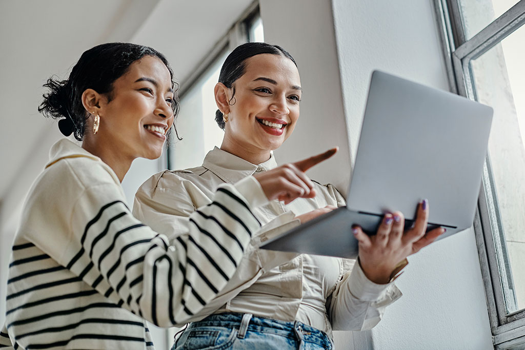 Young woman looking at laptop at work