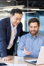 Business men looking at laptop