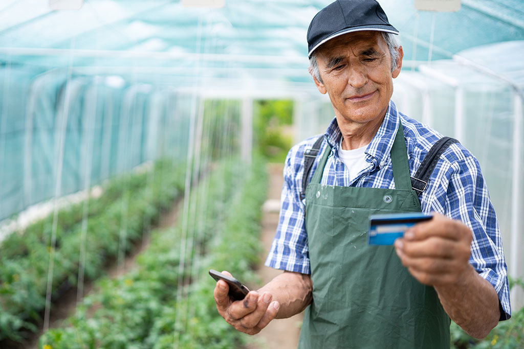 Local farmer holding credit card