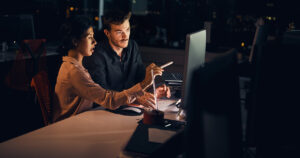 Business people looking at desktop computer
