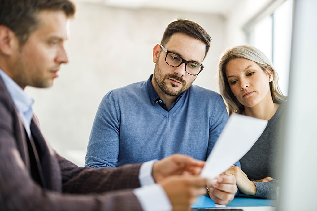 Couple talking with business advisor