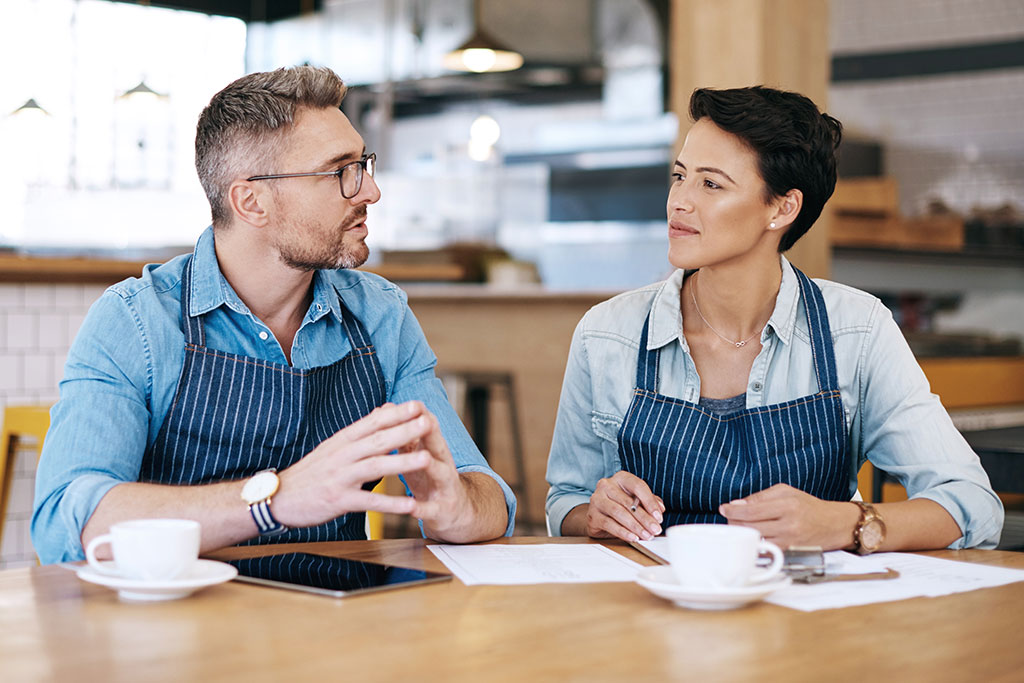 Small business owners sitting down talking