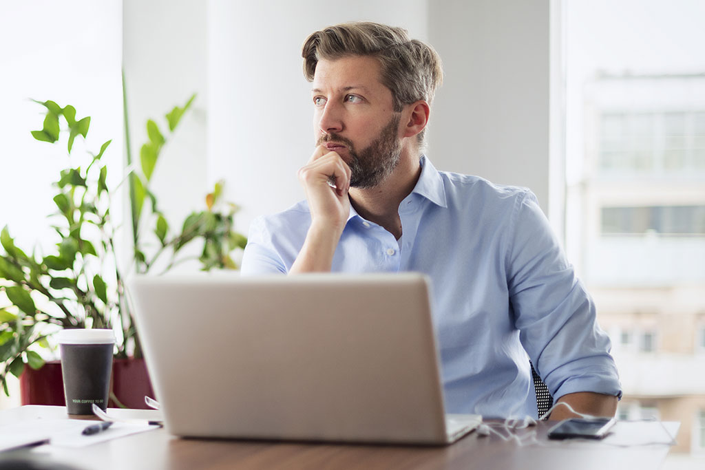 Man looking outside while working
