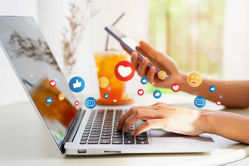 Laptop social media icons above graphics