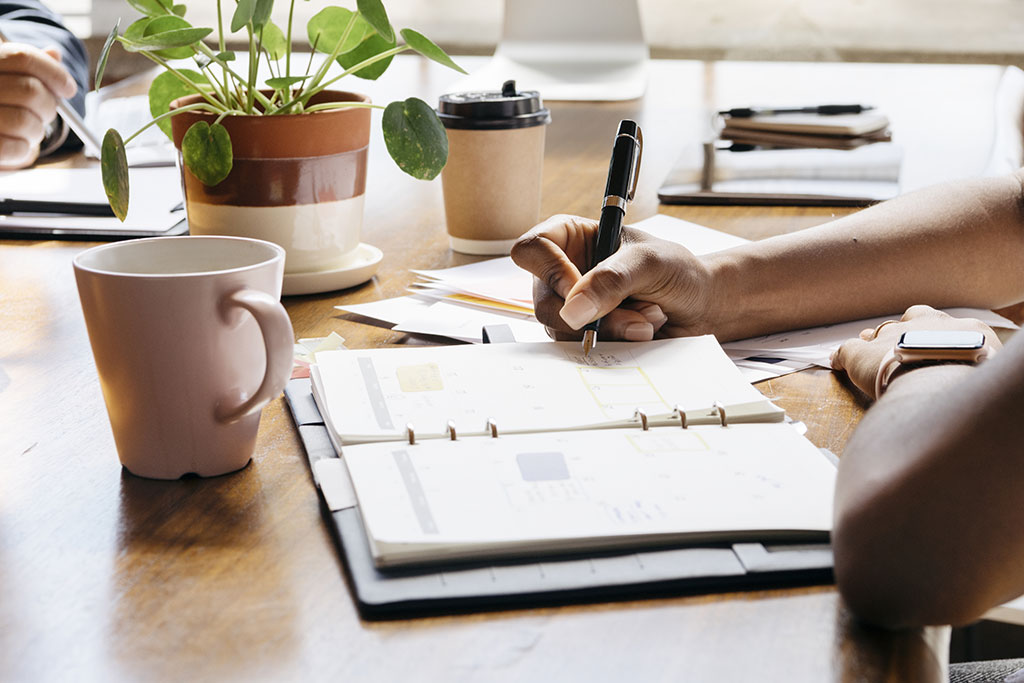Person writing in schedule