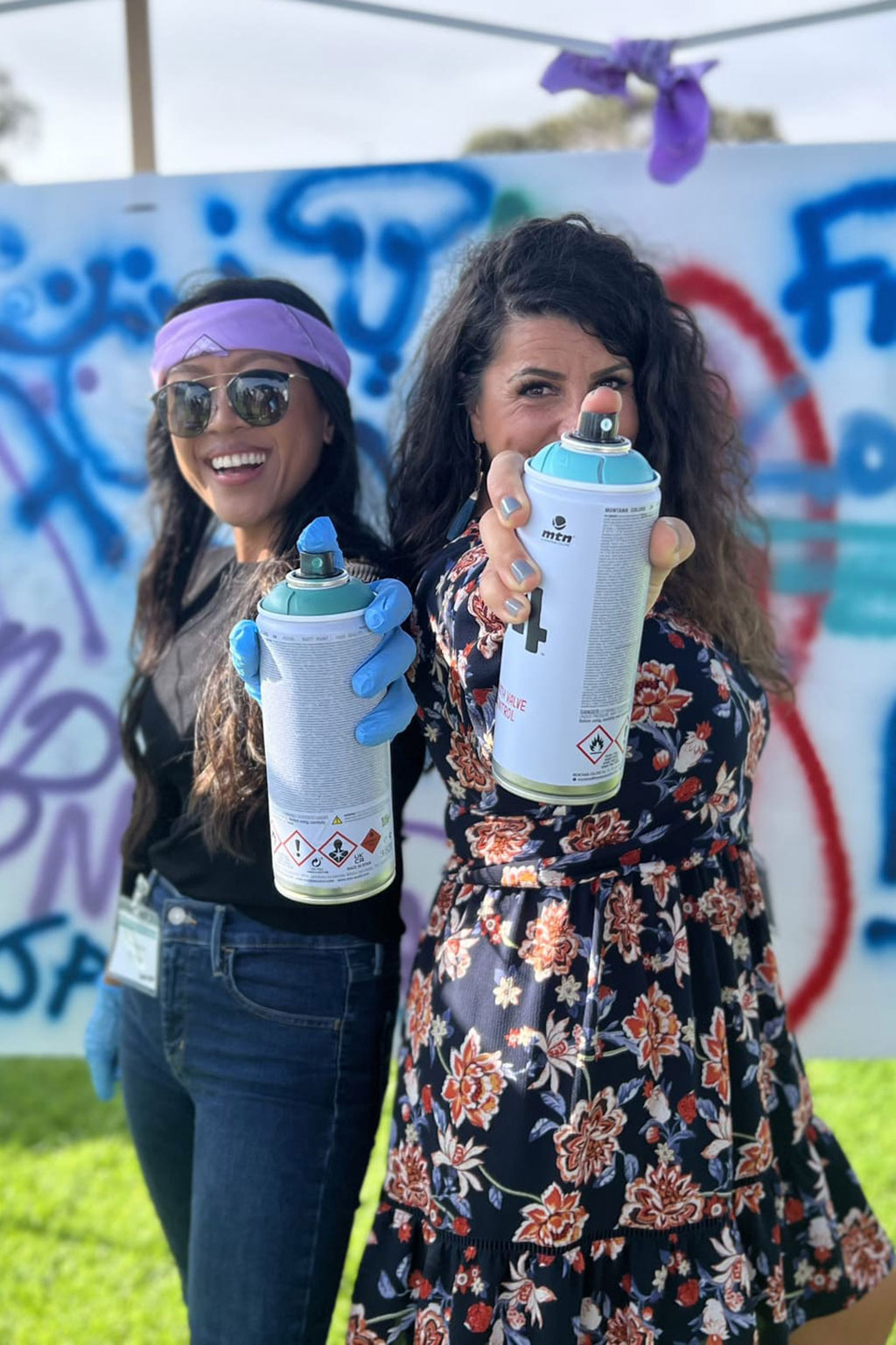 Woman holding spray painting cans
