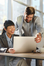 Business people looking at laptop